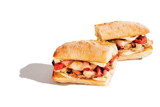 Grilled chicken sandwiches with roasted red peppers and melted cheese on ciabatta rolls.
