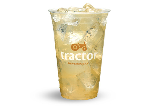 Lemonade tractor drink, in a transparent plastic cup with ice cubes.
