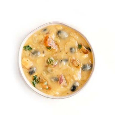 Creamy soup with black olives, tomatoes, cilantro, and melted cheese.
