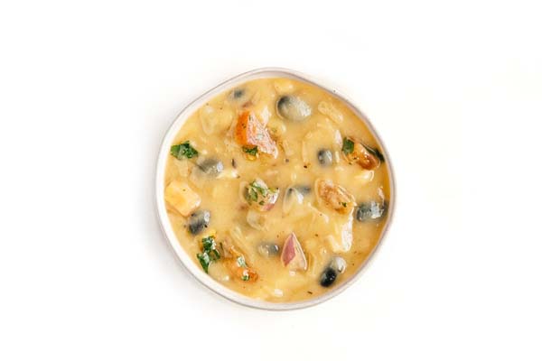 Creamy soup with black olives, tomatoes, cilantro, and melted cheese.