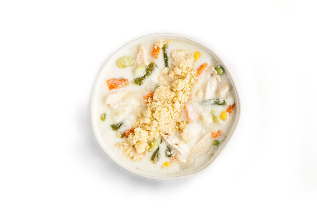 Creamy chicken and vegetable soup topped with crumbled biscuit or cornbread.