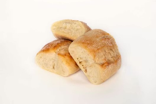 Three pieces of golden brown bread rolls on a plain white background.