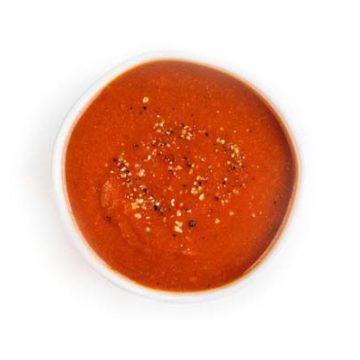 Tomato soup topped with cracked black pepper.