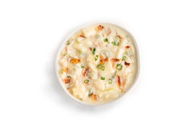 Creamy potato soup with bacon bits and chopped green onions.